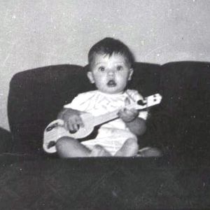 Ronnie Dunn at 6 months old with his first guitar.